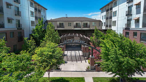 Courtyard entrance with pergola and surrounding buildings at Liberty Gateway Apartments, Salt Lake City, Utah