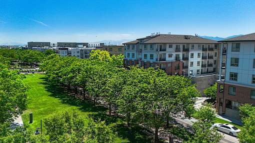 Courtyard with green space and mature trees at Liberty Gateway Apartments, Salt Lake City