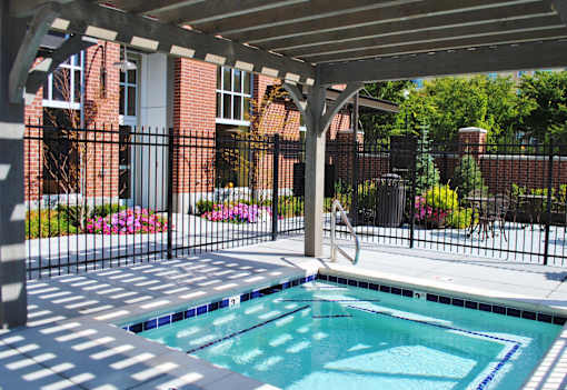 Liberty Gateway Apartments, Salt Lake City, Utah, a hot tub spa under a roof with a black fence around it.