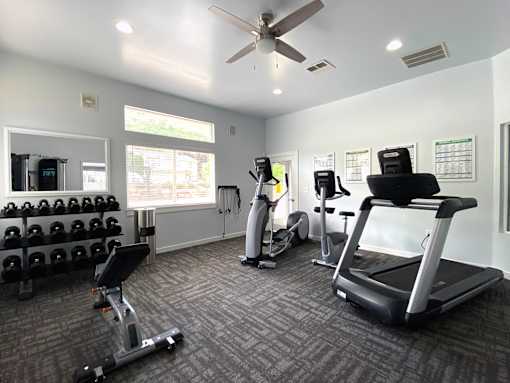 Fitness center with cardio and weight equipment at Liberty Hill Apartments, Draper