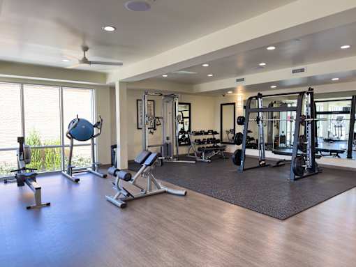 A spacious home gym with a variety of equipment.