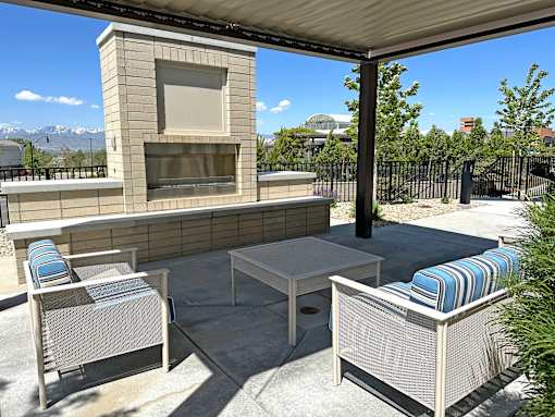 Outdoor patio with fireplace and lounge seating at Liberty Point Apartments, Draper, 84020