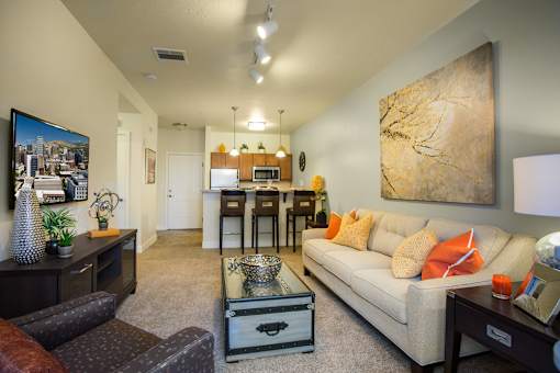 Liberty Gateway Apartments, Salt Lake City, Utah, A living room with a couch, coffee table, and a painting on the wall.