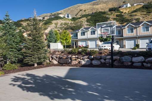 Basketball court with townhomes and mountain views at Liberty Hill Apartments, Draper, Utah
