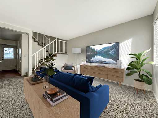 Contemporary living space with staircase and blue seating at Liberty Hill Apartments, Draper, Utah