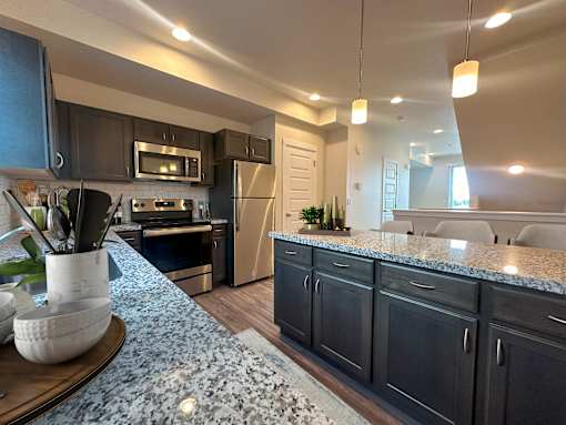 Open kitchen with stainless steel appliances at Liberty Point Apartments, Utah, 84020