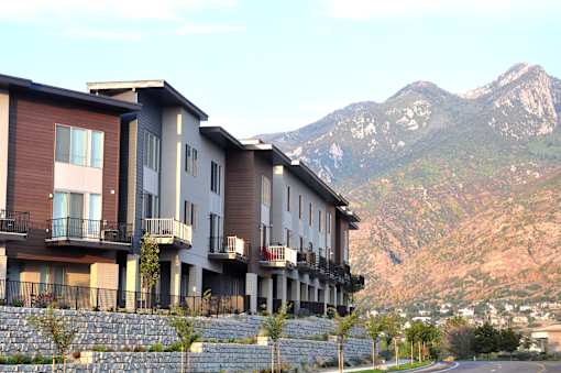 Multi story residential buildings with mountain backdrop at Liberty Point Apartments, Draper, 84020