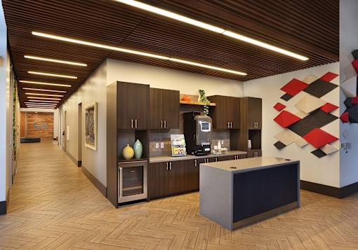 A modern kitchen with wooden floors and cabinets.