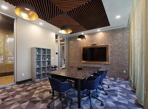 A conference room with a long table and chairs.