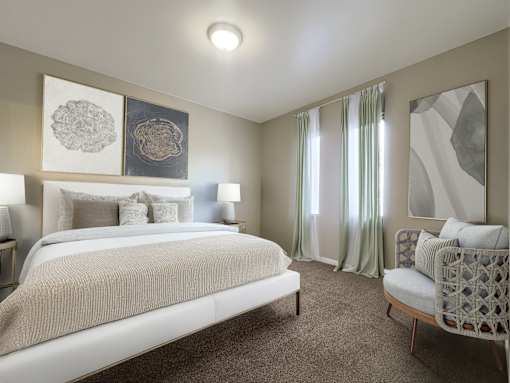 A bedroom with a large bed and a chair.