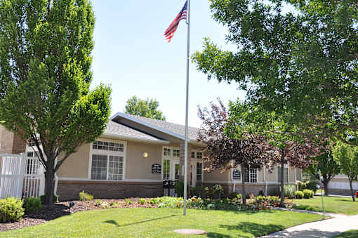 A building with a flag on a pole in front of it.