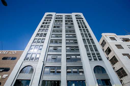 A tall white building with the name "Cotile Co" on the side.