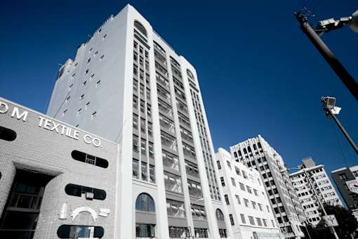 A tall white building with the words "DM Textile Co" on the side.