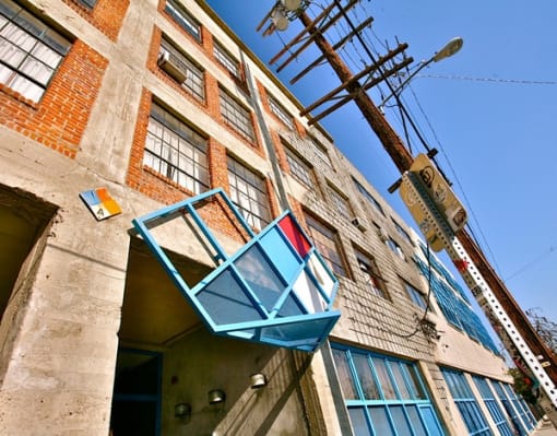 an old building with a window on the side of it at Binford Lofts Apartments, California