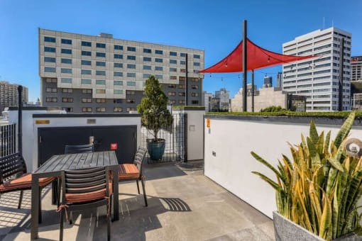 a roof terrace with a table and a red umbrella at Mikado Little Tokyo, California