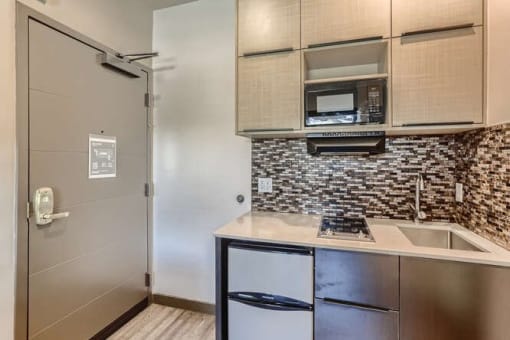 a kitchen with a sink and a refrigerator at Mikado Little Tokyo, Los Angeles, CA 90012