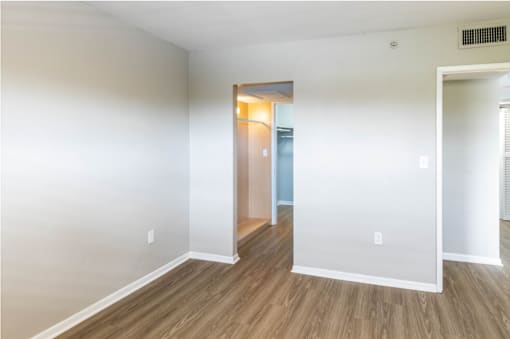 a bedroom with hardwood floors and white walls at Lakeside @ Biscayne Gardens,North Miami, Florida,33181