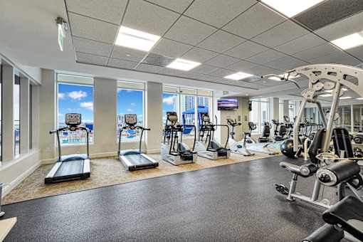 A well-equipped gym with treadmills, exercise bikes, and weight machines.