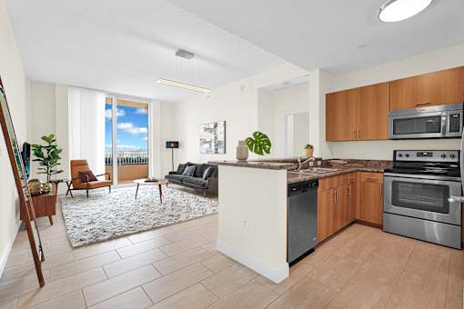 A modern kitchen with a large island and stainless steel appliances.