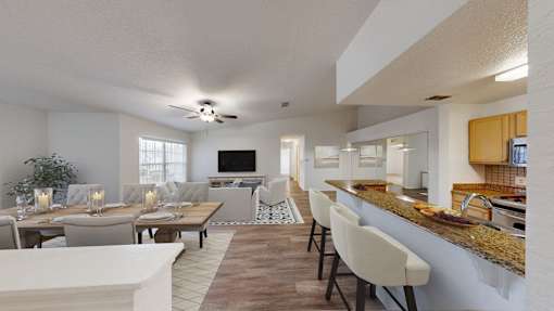 a living room and dining room with a table and chairs