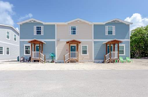 A row of houses with a blue sky in the background.