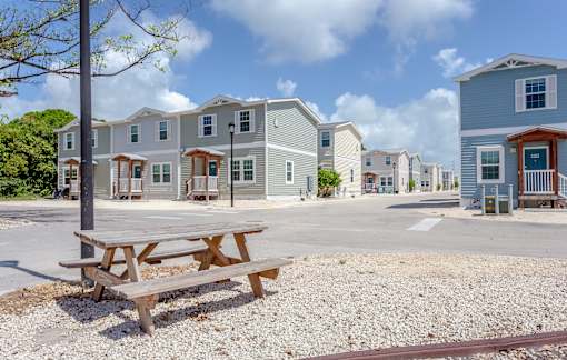 A row of houses with a picnic table in front.