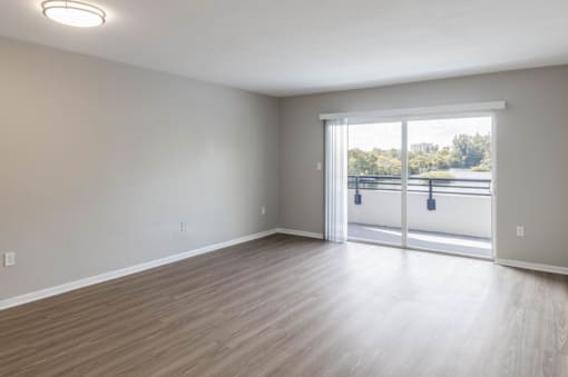 a bedroom with a sliding glass door and hardwood floors at Lakeside @ Biscayne Gardens,North Miami