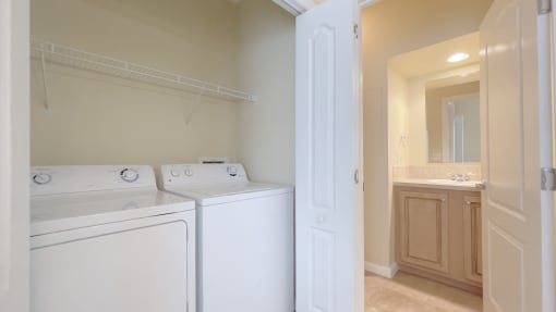 A white washing machine and dryer in a laundry room.