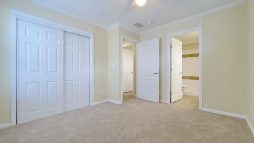 A white door is in a room with beige walls.