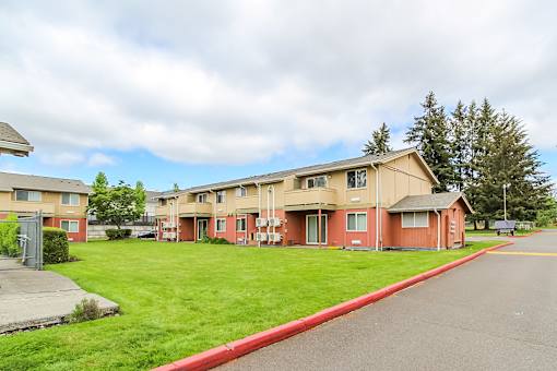 Apartment complex with a red curb in front.