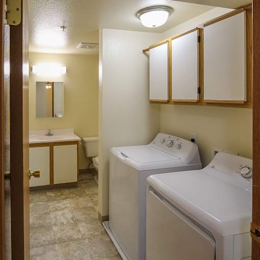 A bathroom with a toilet, sink, and mirror.
