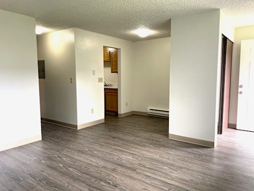 A room with a wooden floor and white walls.