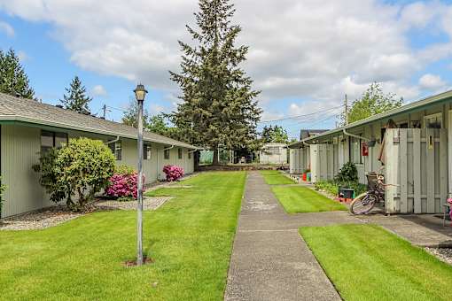 A long pathway leads between two rows of identical buildings.