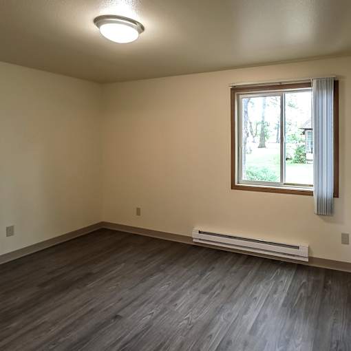 A room with a window and a wall-mounted light fixture.