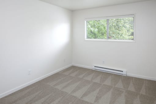 a small room with white walls and a window