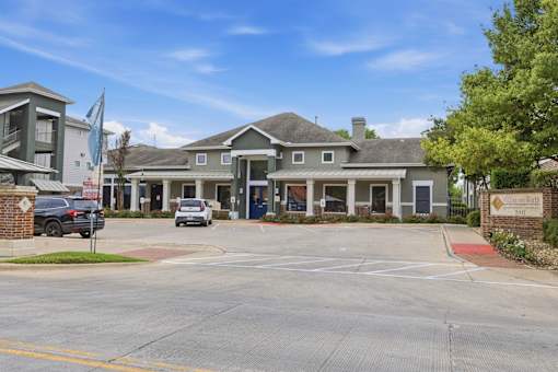 A large building with a parking lot in front of it.