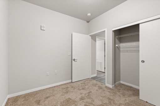 a bedroom with a closet with built-in shelving