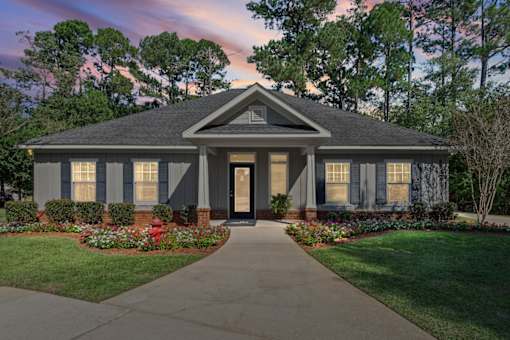 A house with a front yard and a driveway.