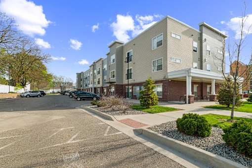 A parking lot in front of apartment buildings.