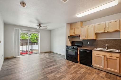 A kitchen with wooden cabinets and black appliances.