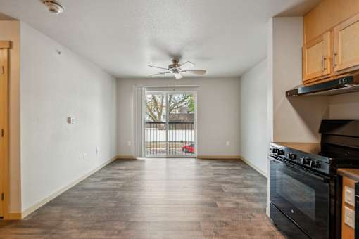 A spacious kitchen with a black oven and wooden cabinets.