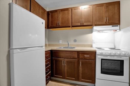 a kitchen with white appliances and wooden cabinets