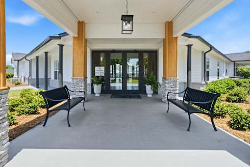 A building entrance with two benches on either side.