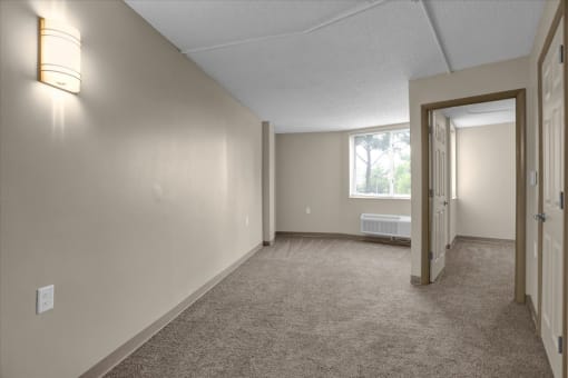 the living room and dining room of an empty home with a window