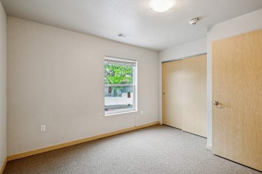 A room with a window and a door.