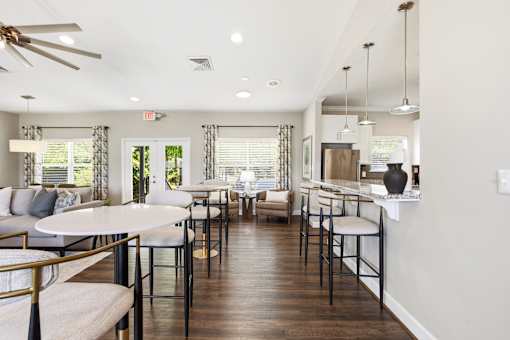 A well-lit, modern dining area with a white table and chairs.