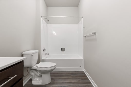 a River Flats bathroom with a toilet and a tub/shower and a sink