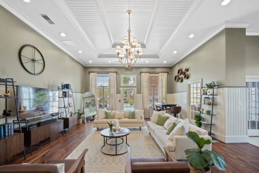 A large resident clubhouse with a big tv and lots of seating at Centerville Manor