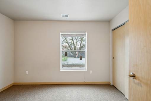 A room with a window and a door.