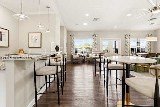 A modern kitchen with a bar area and a dining table.
